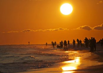 MustDo.com | Sunset on Siesta Beach on Siesta Key Sarasota, Florida. Photo by Marjie Goldberg Photography.