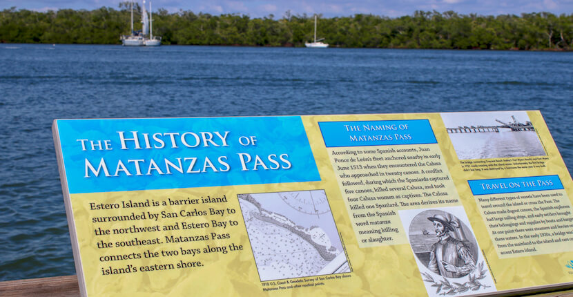 The Mound House history of Matanzas Pass sign. Visitors to The Mound House in Fort Myers Beach, Florida can enjoy fishing and wildlife spotting from the Observation Pier, take a kayak or boat tour, a relaxing stroll through the historic gardens, or enjoy a picnic. Must Do Visitor Guides, MustDo.com.
