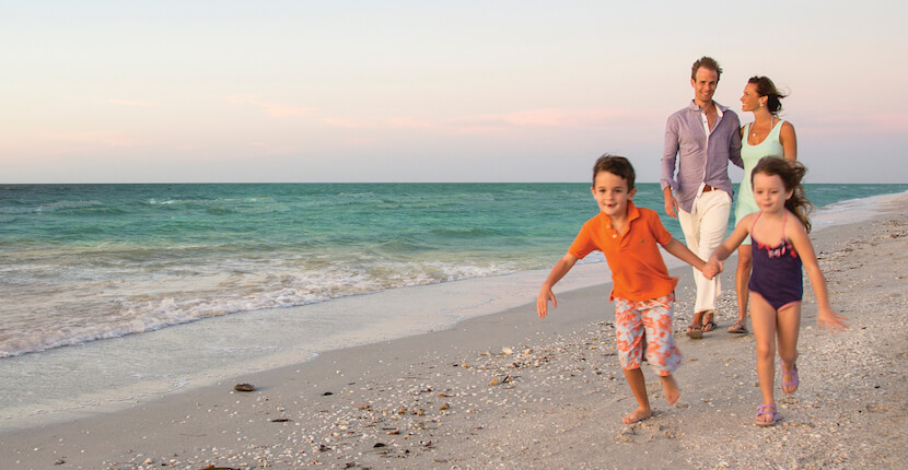 Family on the beach at Sundial Beach Resort on Sanibel, Florida.