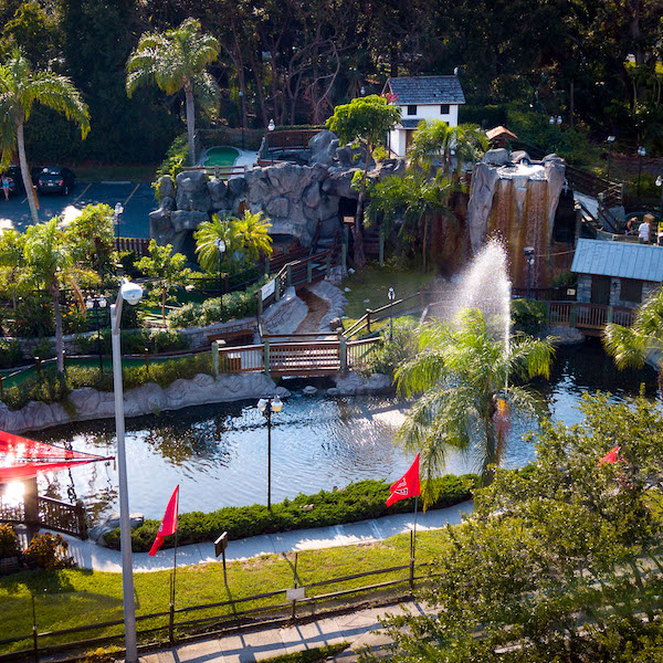 Play 18 holes of challenging mini-golf in a lush tropical setting amid waterfalls, caves, pirate ships, and live alligator at Smuggler's Cove in Sarasota, Florida.