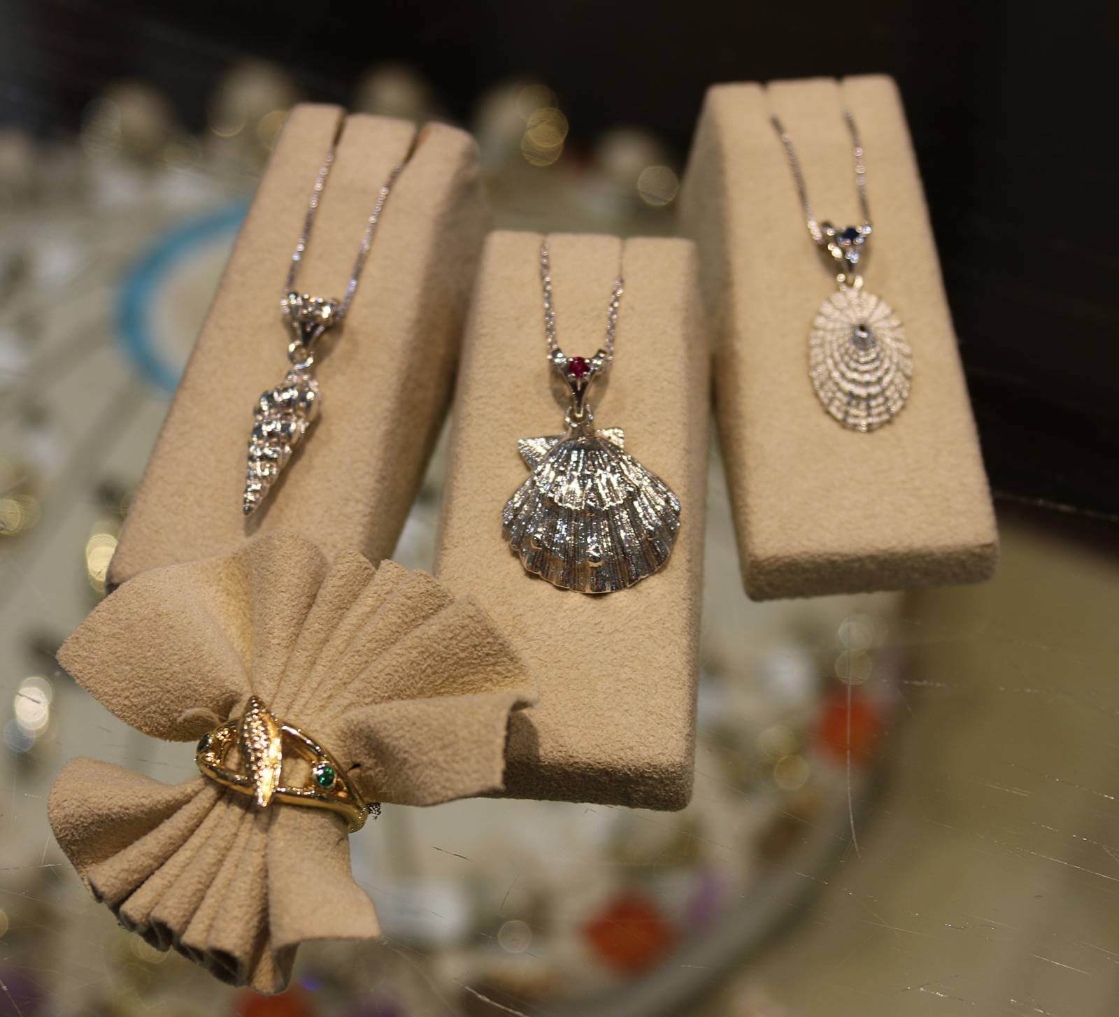Shell pendants and ring. Designer and signature island-inspired fine jewelry paired with personalized service and quality workmanship at Congress Jewelers on Sanibel, Florida.