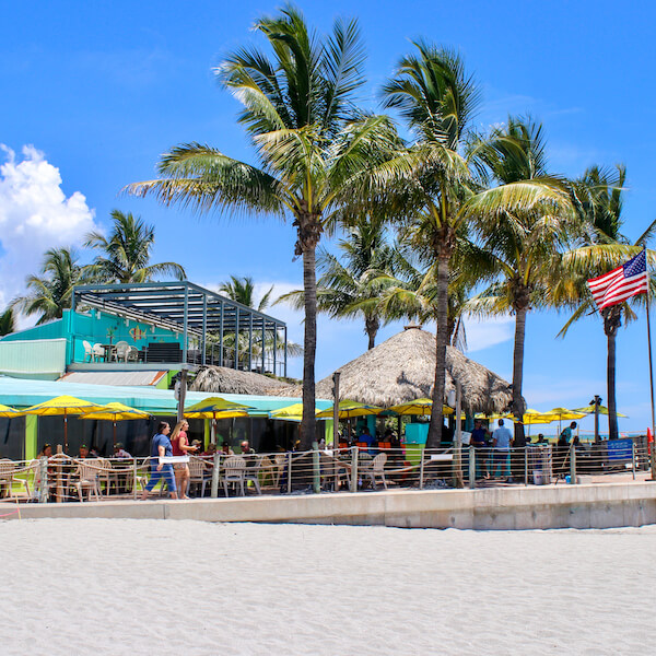 Sharky’s on the Pier is a popular beachfront bar and restaurant spot located directly on the Gulf of Mexico in Venice, Florida. Photo by Nita Ettinger. Must Do Visitor Guides MustDo.com