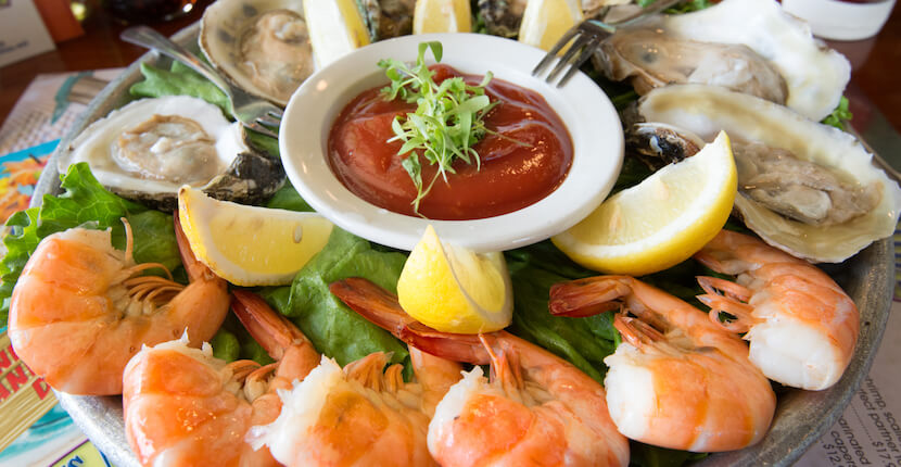 Peel and eat shrimp with fresh oysters on the half shell at Nervous Nellie's waterfront restaurant in Fort Myers Beach, Florida.