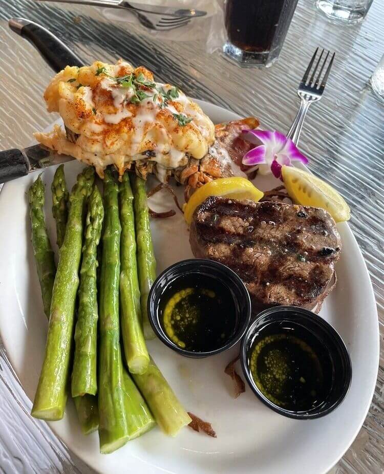 Steak and lobster with grilled asparagus at Matanzas on the Bay Fort Myers Beach, Florida waterfront restaurant.