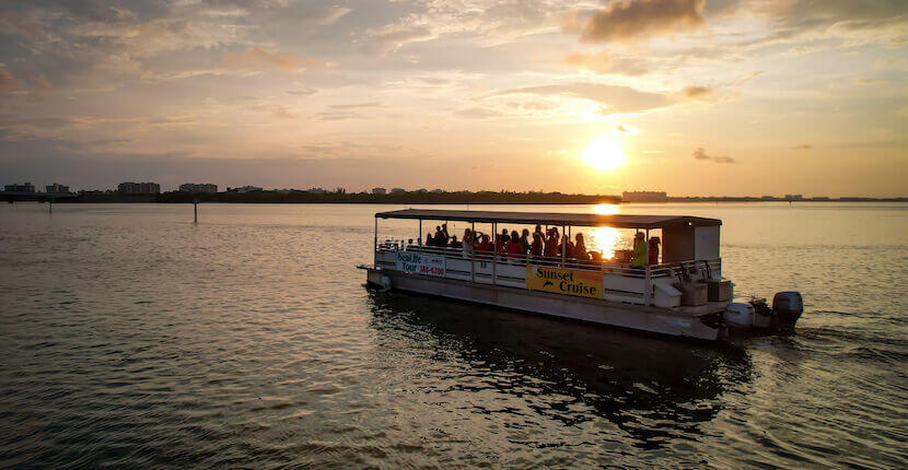 Boat with people enjoying a relaxing sunset boat cruise with Sarasota Bay Explorers in Sarasota, Florida.