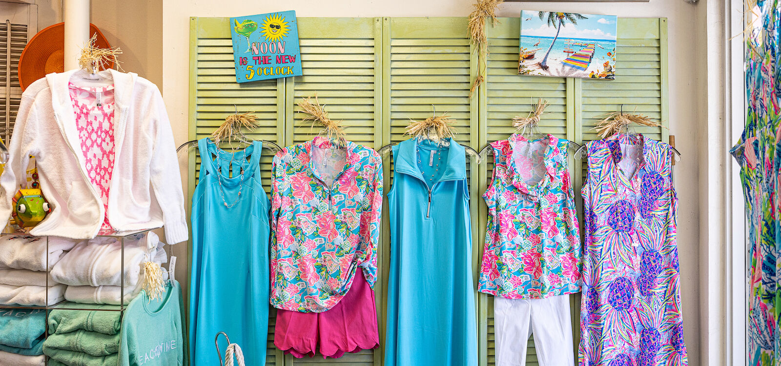 Brightly colored women's dresses, shirts, and skirts hang on a shop wall in Naples, Florida. Photo by Jennifer Brinkman