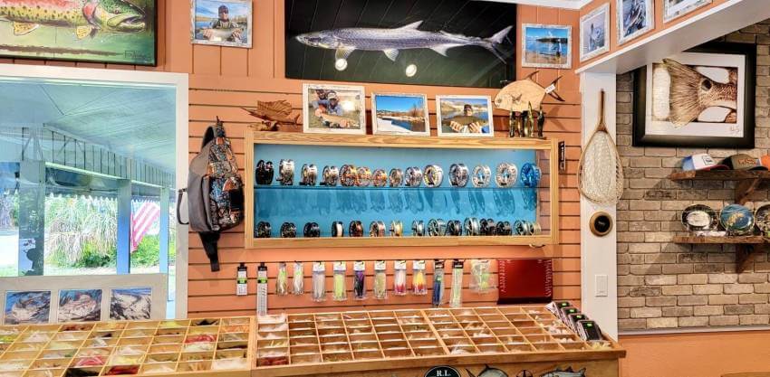 Interior store of Sanibel's Fly Outfitters with display of fly fishing gear and artwork